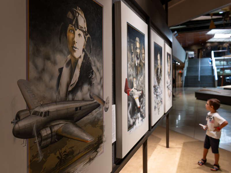 Gabriel at the EAA Aviation Museum with an Amelia Earhart portrait in the foreground, Oshkosh, Wisconsin, US