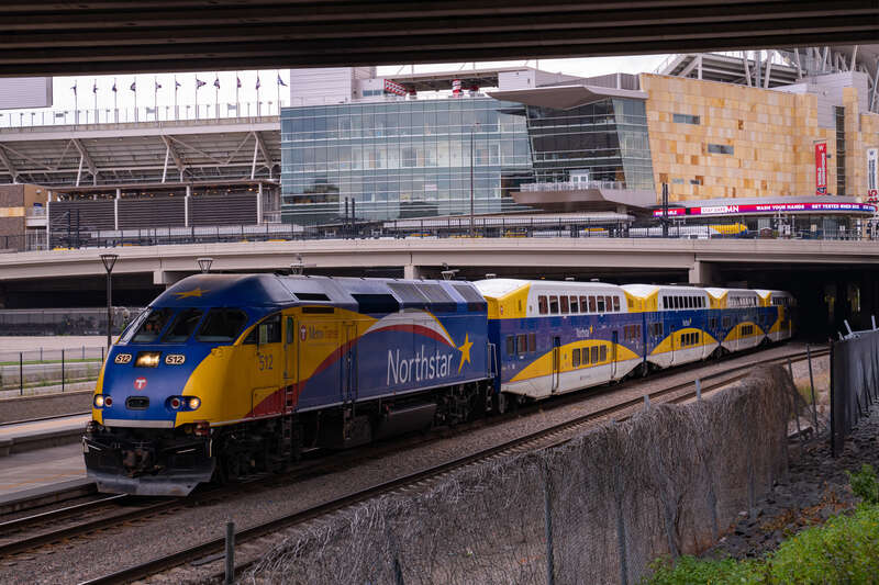 The Northstar Train at the Target Field Station in Minneapolis. Above is Target Field, home of the Minnesota Twins MLB baseball team. COVID-19 warnings scroll on the digital board.