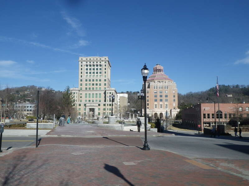 The view from Pack Square in Asheville, NC of the Buncombe County Courthouse (on the left) and the Asheville City Building (on the right).  They were both built in the 1920s and originally were supposed to look similar.  However, the Buncombe County