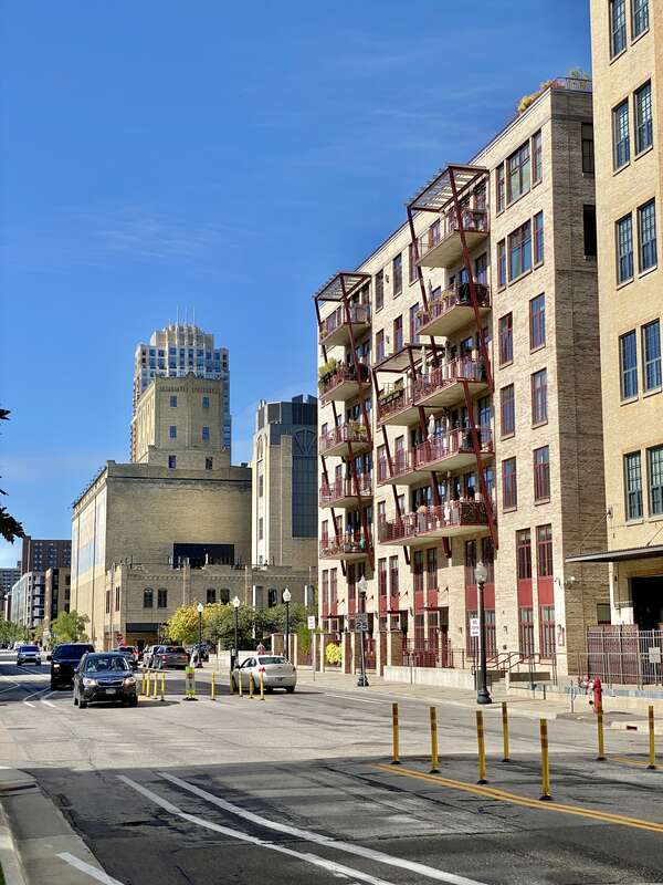 In the background, on the left, built in 1908, this former grain elevator was historically known as the Northwestern Consolidated Milling Company Elevator A, or Standard Milling Company Mill, and was designed by G.T. Honstain.  The building was built