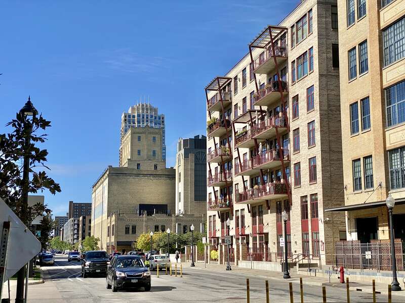 In the background, on the left, built in 1908, this former grain elevator was historically known as the Northwestern Consolidated Milling Company Elevator A, or Standard Milling Company Mill, and was designed by G.T. Honstain.  The building was built
