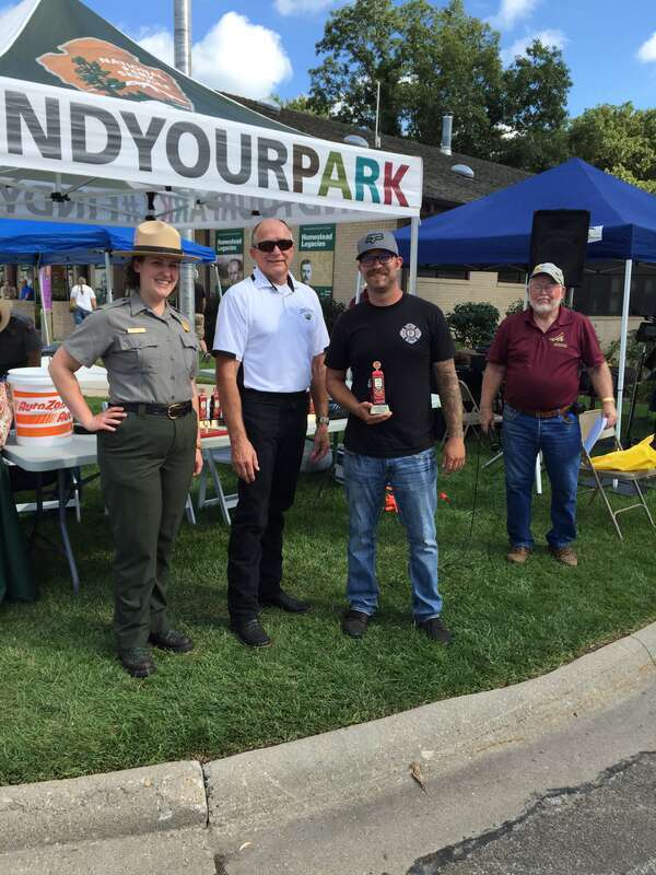 A park ranger and other car show officiants present awards at the 2019 car show.
Car show coordinators present awards.