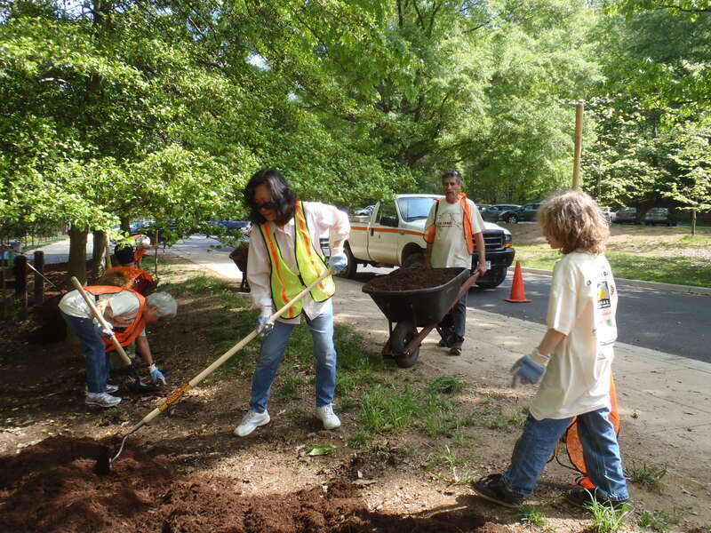 Volunteers spread mulch throughout the day use area and concession stand.