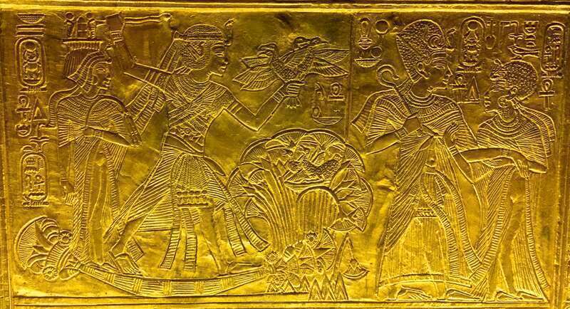 Scene from gilded shrine of Tutankhamen showing him and his wife Queen Ankhesenamun. King and Queen on a papyrus boat, hunting birds. On the right, Ankhesenamun and Tutankhamun are shown embracing.