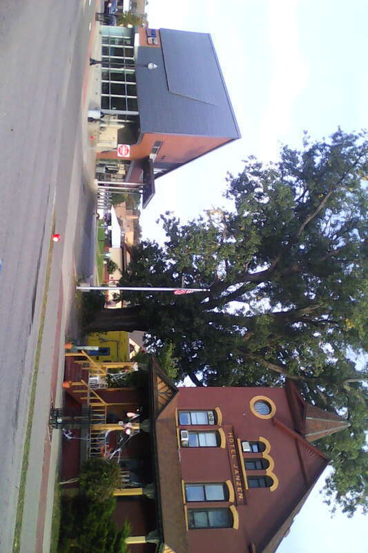 The Hotel Janzen (right) in Marquette, Michigan. To the left is a MarqTran station. Railroad tracks used to run in the angled space between the two buildings