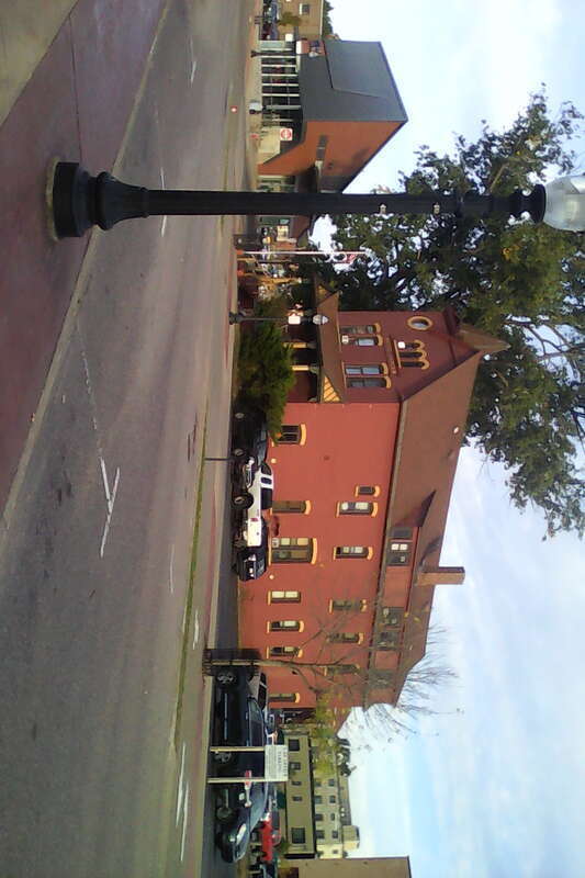 The Hotel Janzen in Marquette, Michigan. To the left is a MarqTran station. Railroad tracks used to run in the angled space between the two buildings