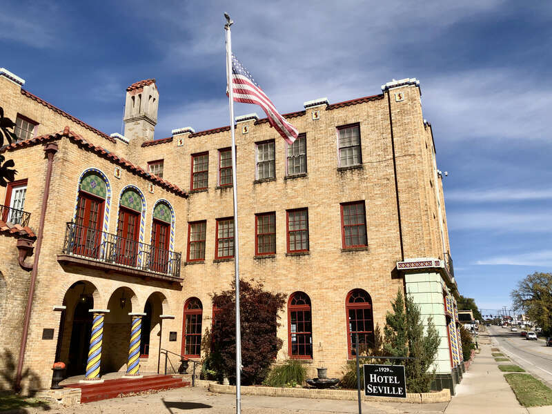 Three-story, Spanish Revival style 57-room hotel, located on North Main St. in Harrison, Arkansas.