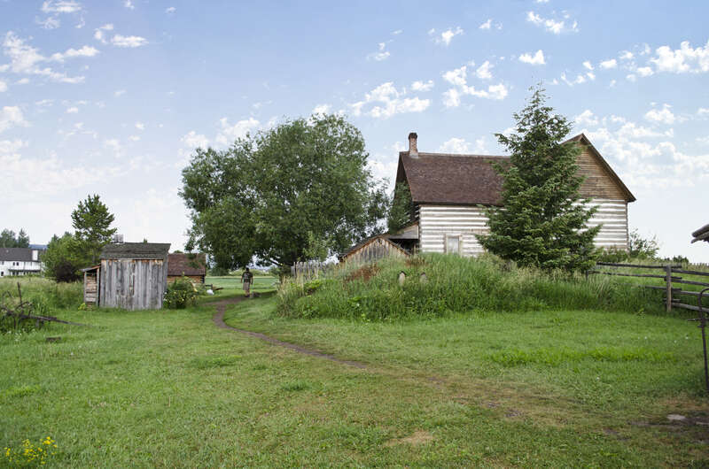 Looking southwest from the blacksmith shop at the root cellar and house on the grounds of the Tinsley Living Farm at the Museum of the Rockies in Bozeman, Montana. The chicken coop is to the left, and behind it the storage shed.
The house was