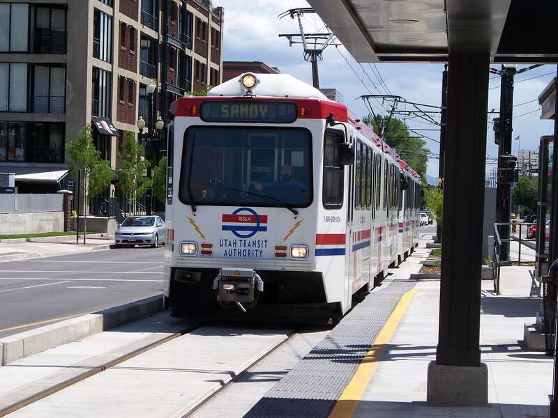 A Blue Line UTA Trax light rail vehicle approaches Planetarium station, 200 S 400 W, Salt Lake City, Utah, United States.