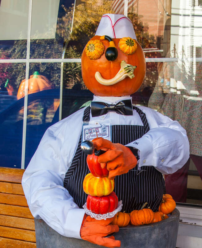 Taken at Damariscotta, Maine's 2016 edition of their Pumpkin Festival.  This is &quot;Pumpkin Jerk&quot;  as distinguished from soda jerk. He has a triple dip cone for someone. 

It is out side the Rexall Drugstore that also houses an old fashioned soda