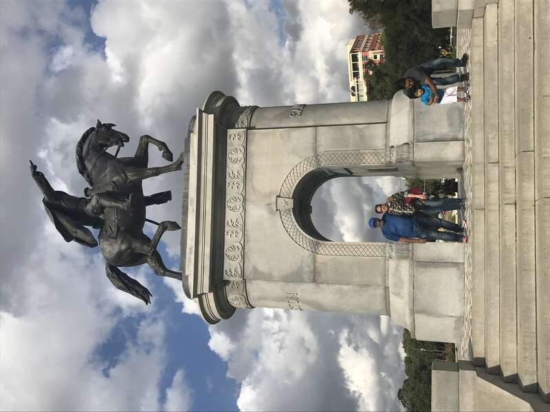 Sam houston on top of his original horse in a military attire, riding for protecting houston; pointing his finger in the way for his army to attack