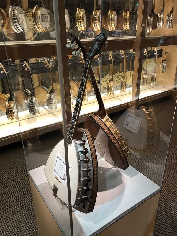 A pair of Washburn ‘’Shrine’’ banjos suits in a case in front of a rite of jazz-age banjos at the American Banjo Museum in Oklahoma City.