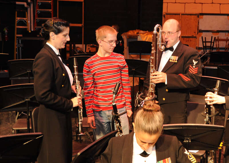110321-N-5508A-020 Bangor, Me  (March 21, 2011) MU1's Shana Catandella and William Kelley, members of the Navy Band clarinet section, show a young student the different kinds of clarinets played during the concert at Bangor High School.  The Navy