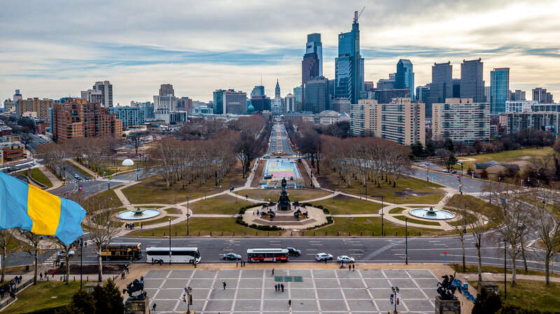 Looking down from the Philadelphia Museum of Art, the Benjamin Franklin Parkway runs vertically through the skyline to the Washington Monument by Rudolf Siemering.