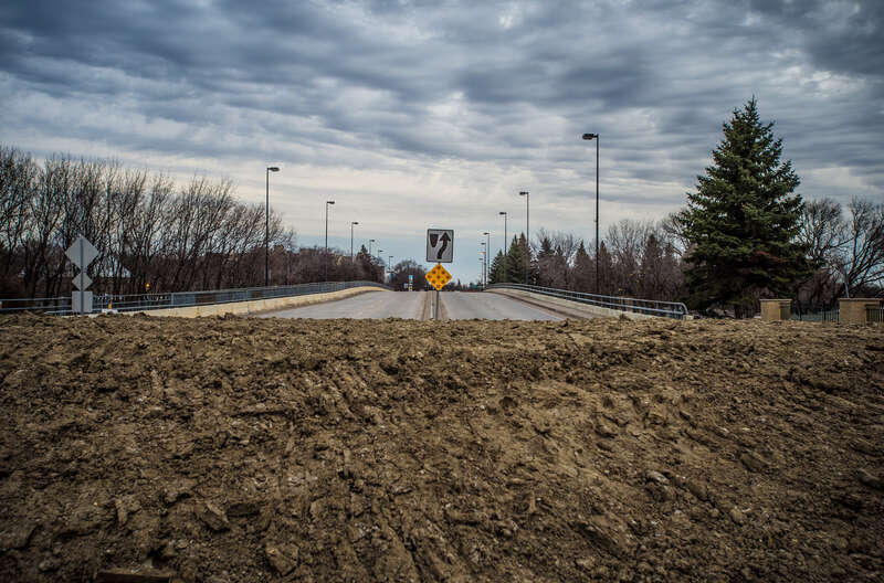 Temporary clay earthen dike at the intersection of 2nd St. N and 1st Ave. N. will prevent Red River flood waters (under the bridge beyond)  from reaching the nearby city hall, in Fargo, N.D. on Monday, Apr. 29, 2013.  To learn about the Red River