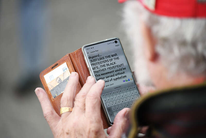 A counter-protester wearing Donald Trump campaign paraphernalia takes notes comparing March on Alaska participants with the Black Panthers.
March on Alaska event in Anchorage, Alaska. Presented by the Alaska Black Caucus. September 7, 2020.

This