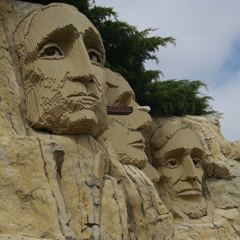 The president's ears are getting swabbed at Legoland California's Miniland.