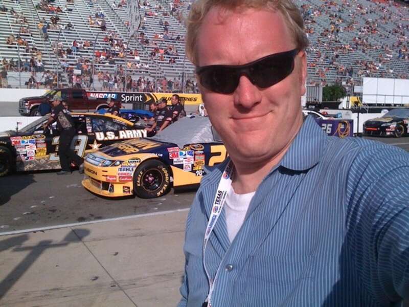 Jay Busbee at the Fall 2009 Bristol Motor Speedway Sprint Cup race. He is in front of the #26 and #39 Sprint Cup cars.