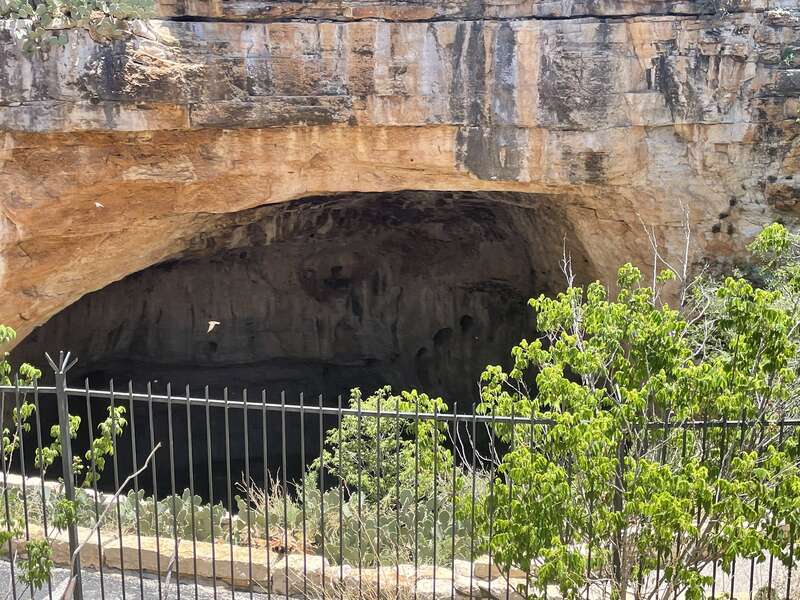 The Lechugilla Cave opening appears as visitors walk from the Visitors' Center.