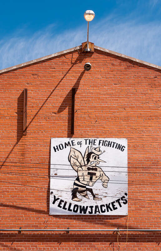 Sign for the Tombstone High School 'Yellow Jackets', on a building on Allen Street in Tombstone, Arizona.