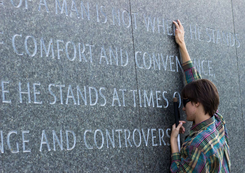 Nie, a blind visitor, reads an etched quotation by touch at the Martin Luther King Jr. Memorial in Washington D.C. on October 21, 2016. The full quotation, stated by Dr. King in 1963, reads: &quot;The ultimate measure of a man is not where he stands in