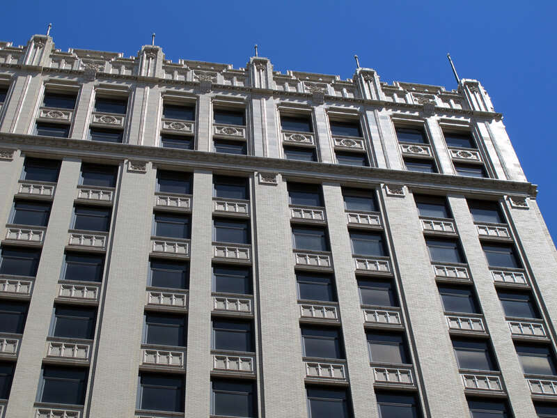 Photo of the upper-level architectural details of the Sharp Building, 206 S. 13th Street, Lincoln, Nebraska.  Photo is of the west side of the building, taken near alleyway south of &quot;N&quot;.