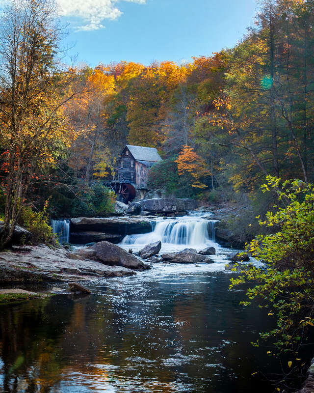 The Glade Creek Grist Mill, set against the symphonic backdrop of West Virginia's Babcock State Park, commands the lens's attention as one of the most celebrated vistas in the region. Its reputation as a photographer's sanctuary is well-earned; an