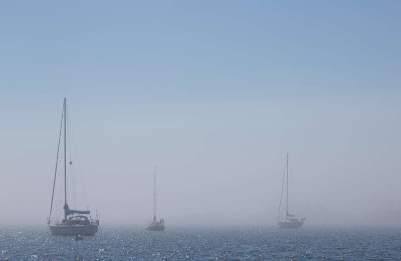 Boats in the Grand Marais Harbor on a foggy afternoon in Grand Marais, Minnesota.