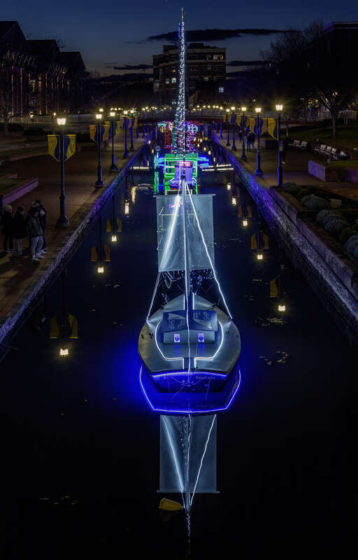 Illuminated holiday boat display in Carroll Creek, Frederick, Maryland, USA