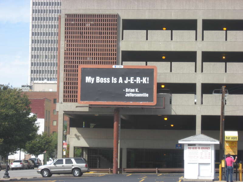 An unusually personal billboard, located along the northern edge of the parking lot on the northeastern corner of the junction of Fifth and Chestnut Streets in downtown Louisville, Kentucky, United States.