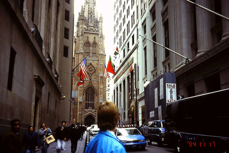 New York City, NY: Wall Street, looking northwest to Trinity Church; November 1994