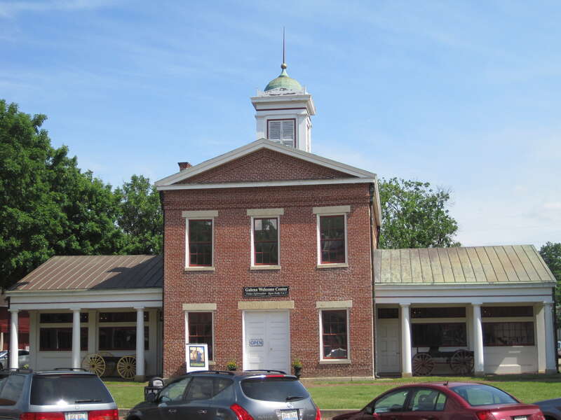 The Old Market House in Galena (1846). With twelve trading stalls, it was the city market until 1910. It also functioned as city hall, with officed upstairs for the city council, surveyor, and market master. There were also two jail cells. The city