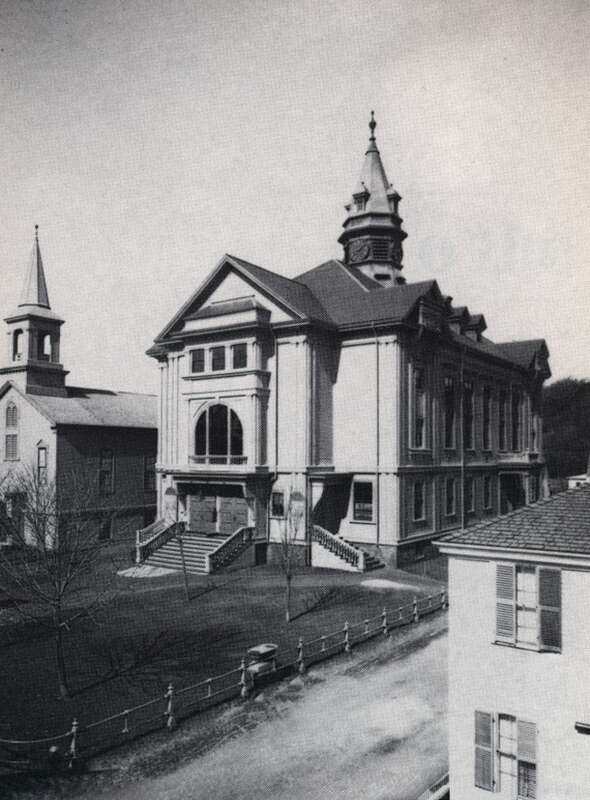 From the website:
This view was taken circa 1905 from an upstairs window in one of the houses across Commercial Street prior to the widening of Ryder Street in 1920. On the lawn are a watering trough and a tablet commemorating the signing of the