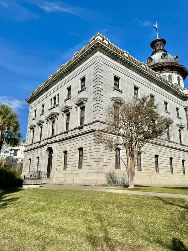 Built in 1851-1907, this Classical Revival-style building was designed by P. H. Hammarskold, John Niernsee, Frank McHenry Niernsee, Frank Pierce Milburn, and Charles Coker Wilson to serve as the state capitol building for South Carolina.  The
