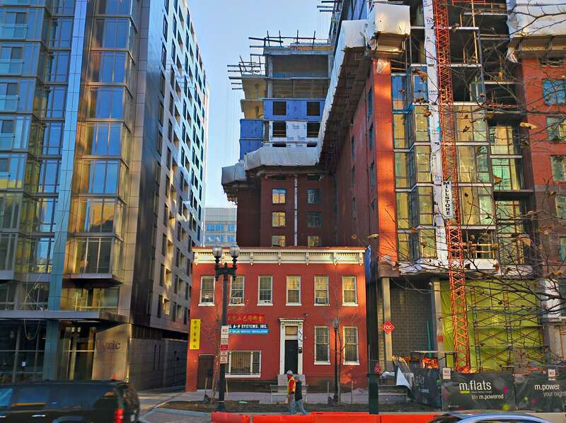 The two Italianate former residences, 444 and 446 K Street NW, were built in 1874 and are designated as contributing properties to the Mount Vernon Triangle Historic District.