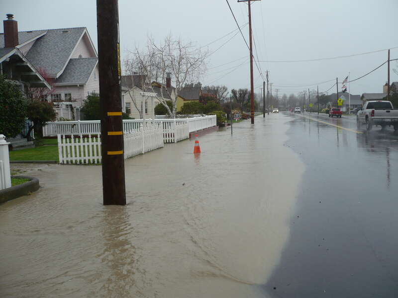 Older homes on Main Street Ferndale, California were built high for days like these.  Francis Creek washed down a large pile of sediment which ran over the banks in various places throughout town. The brown color comes from sediments washed down from