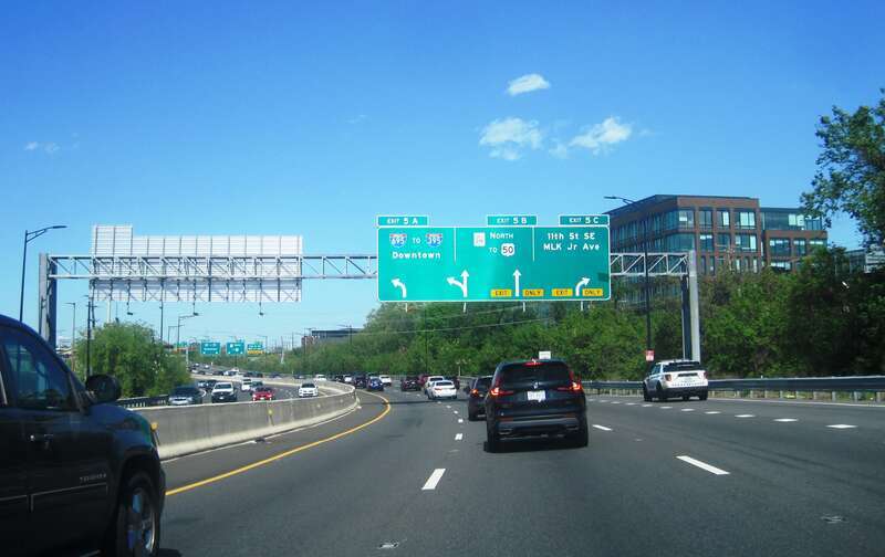 Photo of northbound Interstate 295 (Anacostia Freeway) in Washington, D.C. approaching exits 5A, 5B, and 5C for I-695, District of Columbia Route 295, and 11th Avenue/Martin Luther King Jr. Avenue. Photo taken looking east-northeast between Howard