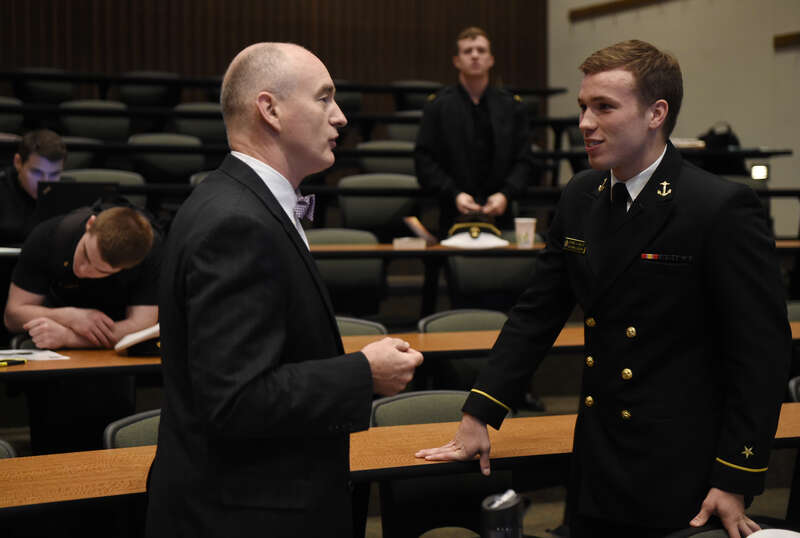 Dr. Larry Schuette, director of research at the Office of Naval Research (ONR), talks with Midshipman 1st Class Michael Woulfe, a 2016 Trident Scholar, following a presentation held at the United States Naval Academy. With special funding provided by