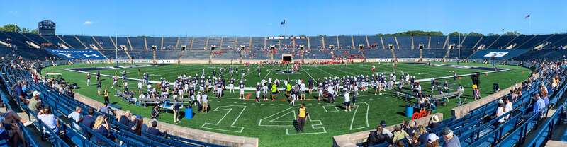 Panoramic image of Yale Bowl, the Yale University football field. Yale/Cornell football game, September 28, 2019. View from home stands; scoreboard at left.