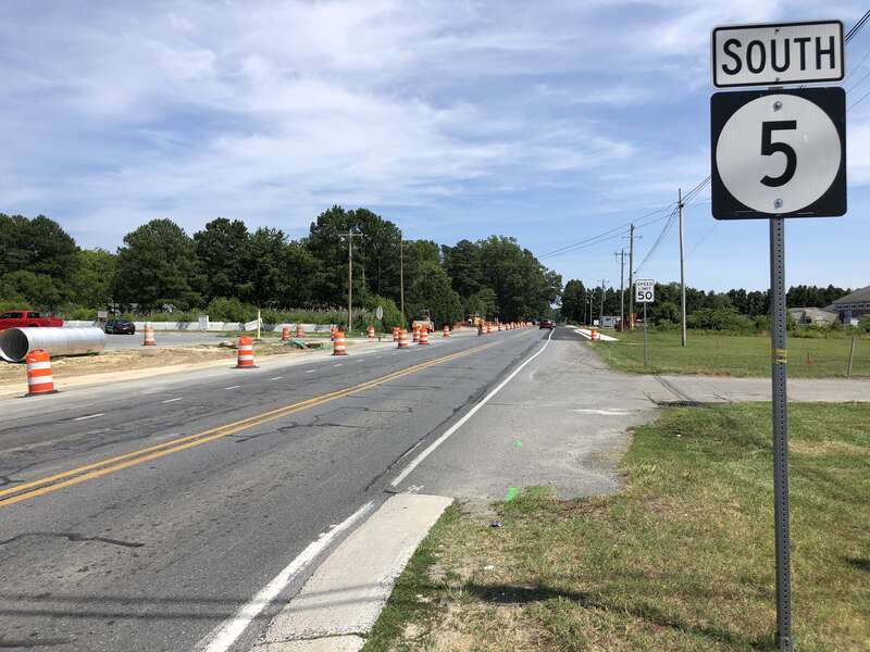 View south along Delaware State Route 5 (Oak Orchard Road) at Delaware State Route 24 (John J Williams Highway) in Harmon, Sussex County, Delaware