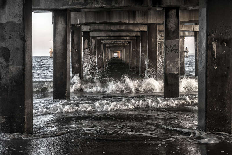 500px provided description: Below Coney Island Pier [#water ,#beach ,#ocean ,#waves ,#pattern ,#pier ,#sand ,#brooklyn ,#symmetry ,#NY ,#New york ,#Coney Island]