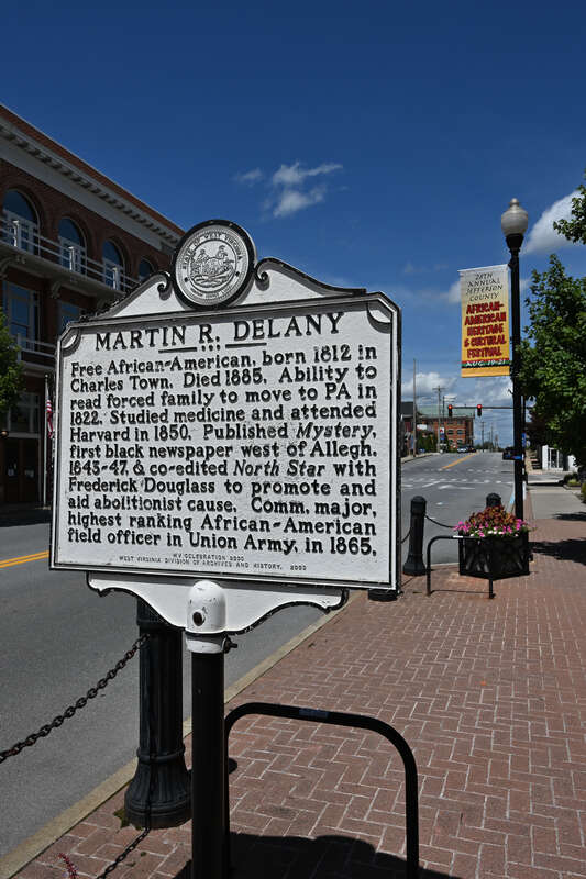 The Martin R. Delany historical marker. Black text on a white sign. It reads: &quot;Martin R. Delany&quot;, &quot;Free African-American, born 1812 in Charles Town. Died 1885. Ability to read forced family to move to PA in 1822. Studied medicine and attended Harvard