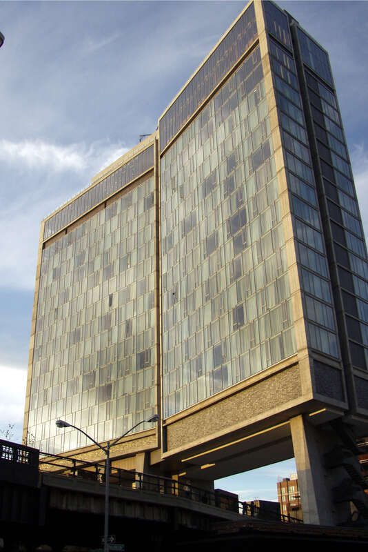 Looking up and north at Standard Hotel from street, near dusk of a sunny day.