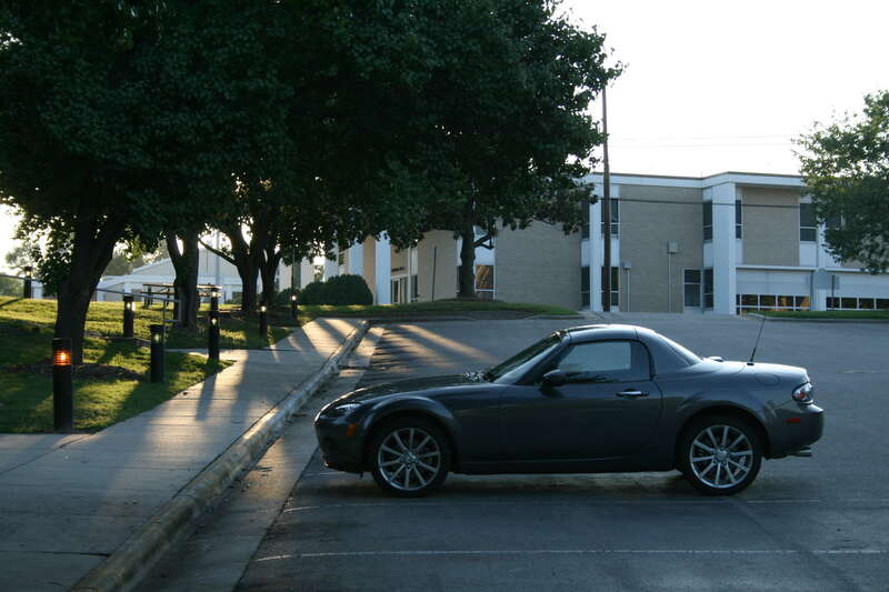 Third generation Mazda Miata in a parking lot in Durham, North Carolina at dusk.