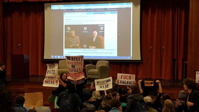 Charles Murray speaks with Middlebury College professor Allison Stanger as students protest.