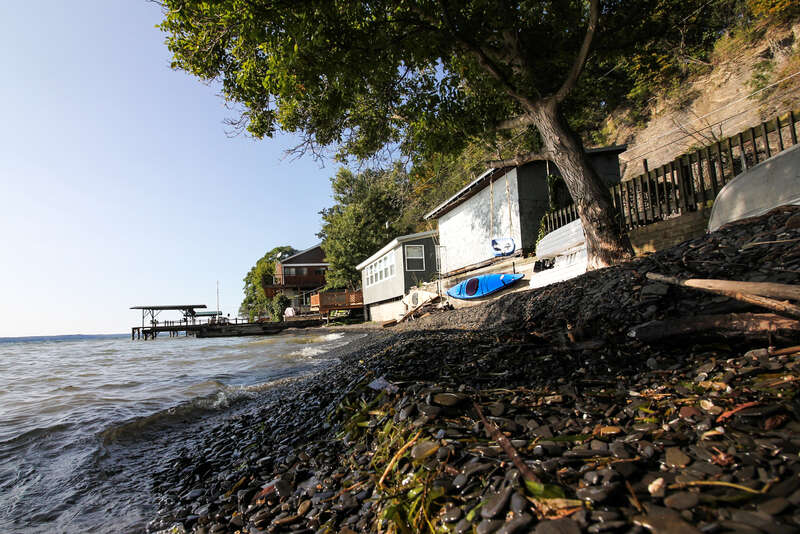 500px provided description: View of the Cayuga lake [#lake ,#stones ,#tree ,#kayak ,#Nature ,#Ithaca ,#Finger lakes ,#New york state]