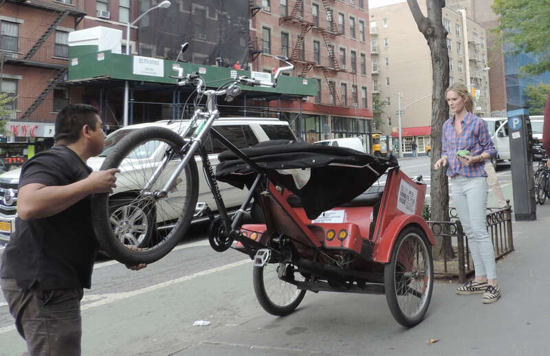 Looking north as worker sets down rampant pedicab. EXIF location is miles east due to photographer's error.