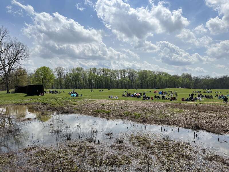 People gathered to watch the April 8, 2024 Total Solar Eclipse at the Angel Mounds State Historic Site. Note the reconstructed palisade to the left of the image.