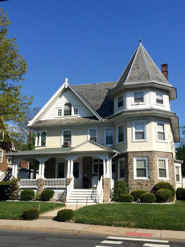 A fine example of "carpenters" Queen Anne architecture with lapped shingles and a hexagonal tower. It is typical of the spacious Victorian houses in the neighborhood.  Built in 1880.