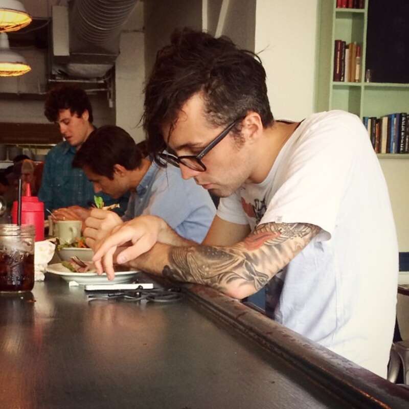 Checking mobile phone messages in a New York cafe.